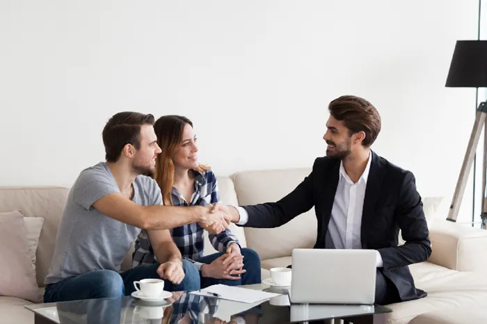 Couple reviewing properties with agent