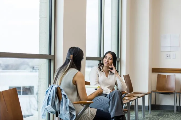 Two women reviewing a budget