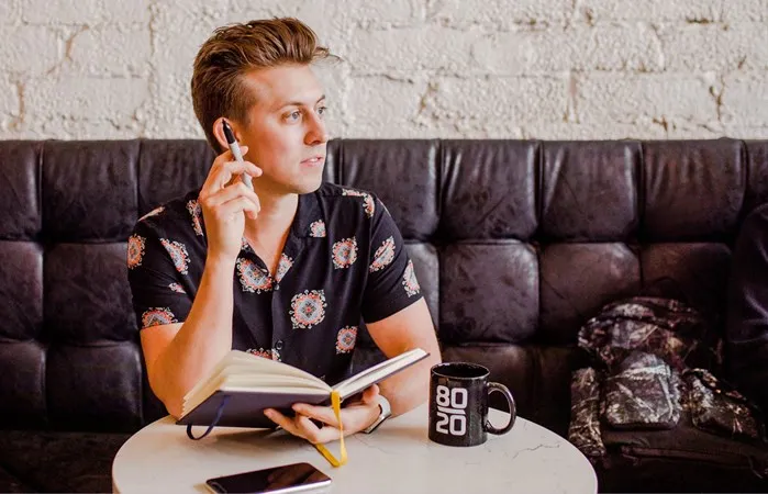man sitting on leather sofa